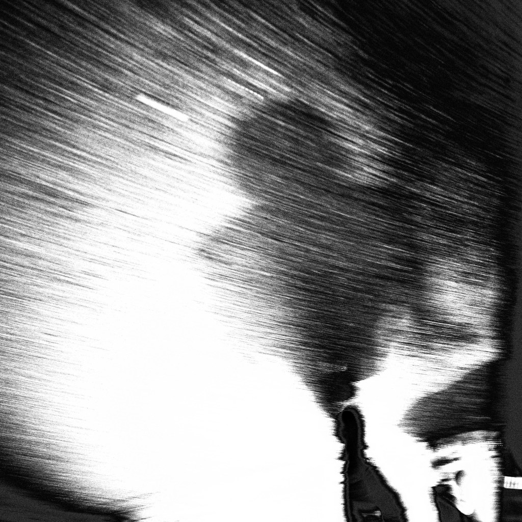 Imagen abstracta en blanco y negro con un efecto de movimiento difuso y sombras.